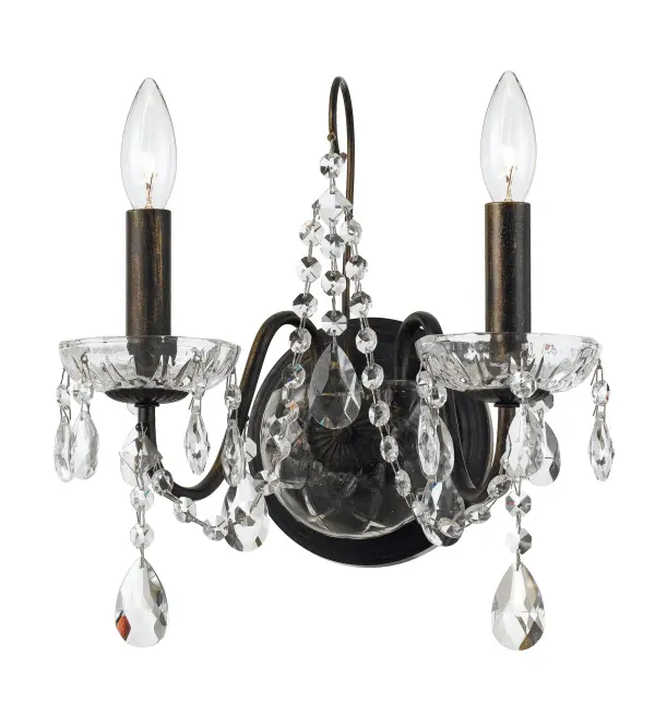 The Butler sconce features graceful crystal strands cascading from a classic English Bronze frame, creating a sophisticated fixture that adds sparkle and elegance to any space. Perfect for bathrooms, bedrooms, and formal areas.