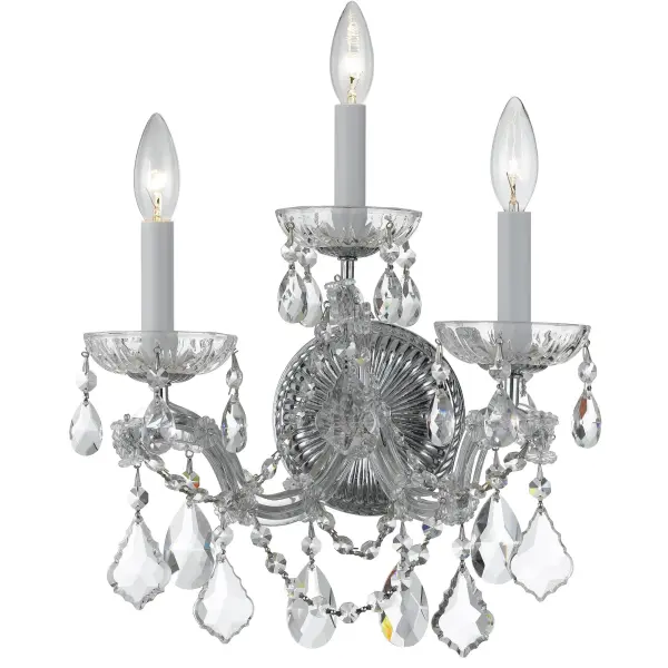 The Maria Theresa sconce brings luxurious traditional style with abundant crystal detailing. Its glass arm frame draped in crystal strands creates stunning light refraction, perfect for adding glamour to bathrooms, bedrooms, or hallways.