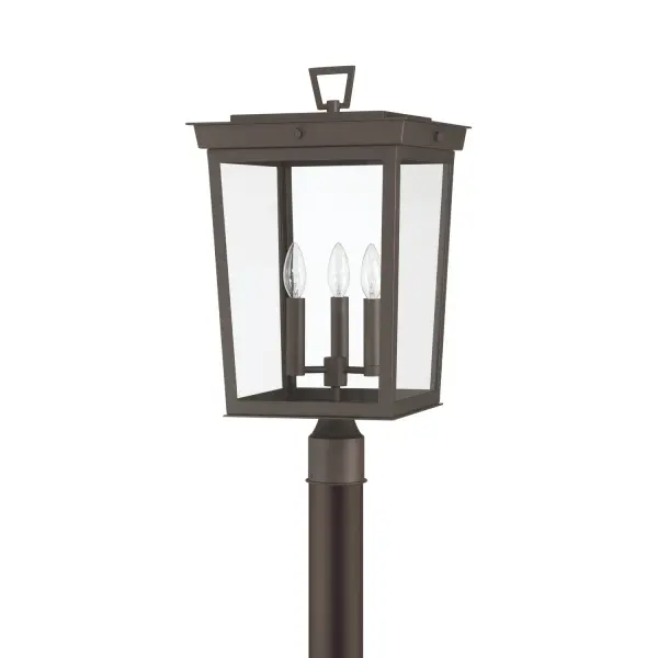 The Belmont outdoor post light combines classic lantern architecture with contemporary design elements. Its tapered rectangular silhouette, clear glass panels, and exposed bulbs create striking curb appeal for any exterior space. - alternate view