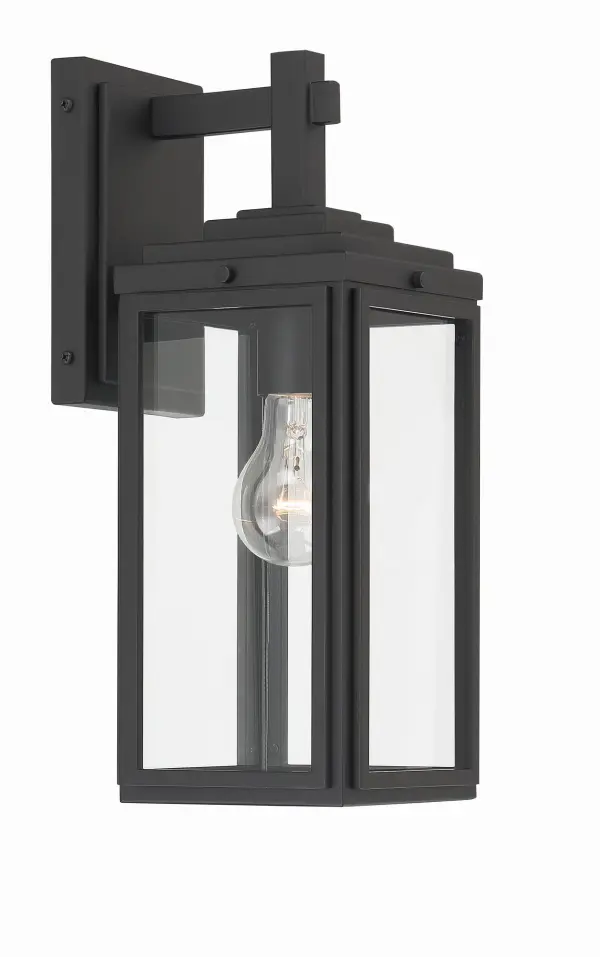 The Byron outdoor sconce combines modern design with transitional appeal through its tapered rectangular clear glass shade and matte black finish. Perfect for enhancing entryways, patios, and terraces with bright, unobstructed light.