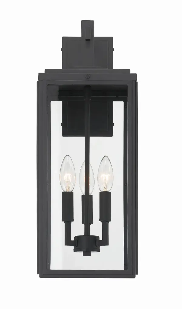 The Byron outdoor sconce combines modern design with transitional appeal through its clean lines and sharp angles. The tapered rectangular clear glass shade provides excellent illumination while the matte black finish adds contemporary sophistication to any exterior space. - alternate view