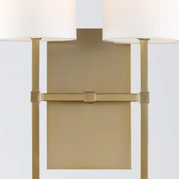 The Veronica sconce combines clean lines with an oversized drum shade for a sophisticated yet understated look. Its minimalist design and warm aged brass finish make it adaptable to various interior styles. - alternate view