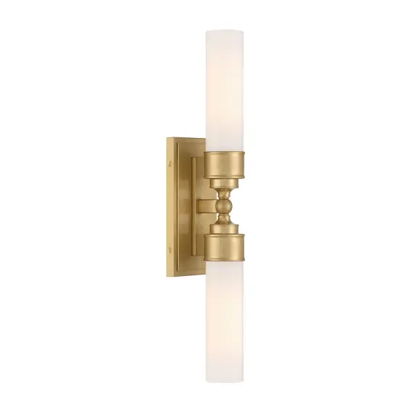 The Wilcox LED Sconce combines clean cylindrical glass with sophisticated stepped detailing in warm Aged Brass. Damp-rated for bathroom use, this compact 4.75" fixture delivers modern elegance with energy-efficient LED technology.