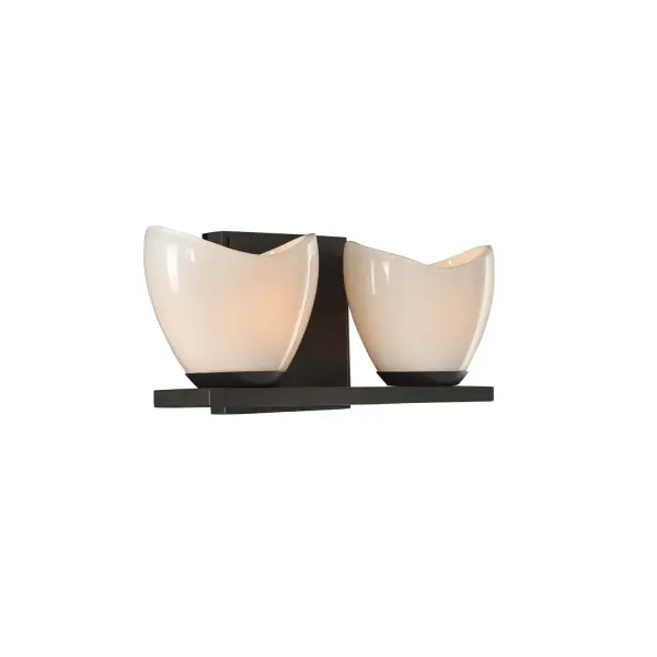 The Vessel Tubs that grace classic and modern upscale bathrooms is the inspiration of the Vero Bath Collection. The Tri-Plex, 3 layer glass is cradled in tapered holders and presented on a spa like platform to emulate the zen feel and glow of candles. Available in Satin Nickel or English Bronze. Collection: Vero Rooms: Bathroom, Vanity, Spa, Powder Room Finish: English Bronze Width: 13.00" Height: 5.00" Weight: 4.00 lb Extension from Wall: 4.00" Wire: 6" Mounting Height: 2.50" Canopy: 5"x5"x0.5" Bulbs Included Number of Bulbs: 2 Maximum Wattage: 3.00 W Bulb Base: G9 Light Source: LED Light Output: 600.00 lm Color Temperature: 3000 K Dimmable Voltage: 120.00 V Material: Heavy Gauge Steel , Opal Glass Country of Origin: China Safety Listing: cETL Safety Rating: Dry ADA LED