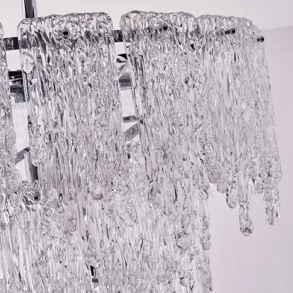 Gisel embraces the unconventional charm of uneven textures that add a touch of uniqueness to any space. Each piece is meticulously crafted to bring nature's marvels, such as icy rivers and their bewitching flows, right to your fingertips. You'll feel a sense of ae as light dances through the layers, casting a spellbinding reflection that captures attention and imagination. This collection is offered in a Polished Chrome finish. Collection: Gisel Finish: Polished Chrome Width: 24.00" Height: 28.00" Weight: 42.00 lb Wire: 96" Rod: (1) 6", (1) 12", (1) 24" Canopy: 5"x2" Number of Bulbs: 10 Maximum Wattage: 40.00 W Bulb Type: Candelabra Bulb Base: E12 Candelabra Dimmable Voltage: 120.00 V Material: Steel and Glass Country of Origin: China Safety Listing: cETL Safety Rating: Dry - alternate view
