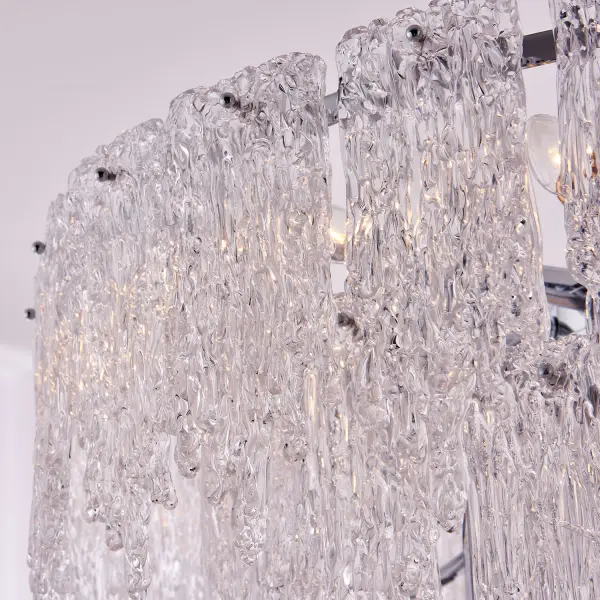 Gisel embraces the unconventional charm of uneven textures that add a touch of uniqueness to any space. Each piece is meticulously crafted to bring nature's marvels, such as icy rivers and their bewitching flows, right to your fingertips. You'll feel a sense of ae as light dances through the layers, casting a spellbinding reflection that captures attention and imagination. This collection is offered in a Polished Chrome finish. Collection: Gisel Finish: Polished Chrome Width: 32.00" Height: 36.00" Weight: 99.00 lb Wire: 96" Rod: (1) 6", (1) 12", (1) 24" Canopy: 5"x2" Number of Bulbs: 19 Maximum Wattage: 40.00 W Bulb Type: Candelabra Bulb Base: E12 Candelabra Dimmable Voltage: 120.00 V Material: Steel and Glass Country of Origin: China Safety Listing: cETL Safety Rating: Dry - alternate view