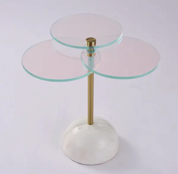 The Petali drink table was inspired by a cherry blossom as outlined in the trio of petal-like glass tops that are adjustable to whatever shape you desire. The table features an authentic white marble base and a trendy brushed brass finish. At a diameter and height of 22″, this would nestle nicely beside any sofa or armchair for a beautiful pop of multi-color and is sure to be a conversation piece. At Modern Elements, our dichroic occasional furniture is a true blend of metals that are fused together to create a glass film. Collection: Petali Finish: Natural Brass Width: 22.00" Height: 22.00" Weight: 67.00 lb Material: Marble, Dichroic Glass, Steel Country of Origin: China - alternate view