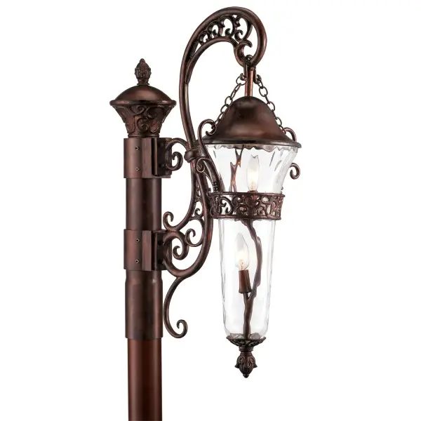 The Anastasia Outdoor collection combines eye-catching Art Nouveau scrollwork with traditional lantern design. The delicate curves of this design are highlighted by Kalco's exclusive Outdoor finishes and our Clear Hammered Glass creates a flickering effect to the eletric lights. This combination is sure to add a touch of whimsical elegance to any outdoor space. Collection: Anastasia Outdoor Rooms: Outdoor, Garage, Patio, Retaining Walls Finish: Burnished Bronze Glass: Clear Hammered Width: 15.00" Height: 37.00" Length: 20.00" Weight: 11.00 lb Extension from Wall: 20.00" Wire: 6" Number of Bulbs: 2 Maximum Wattage: 60.00 W Bulb Type: Candelabra Bulb Base: E12 Candelabra Dimmable Voltage: 120.00 V Material: Aluminum , Glass Country of Origin: China Safety Listing: cETL Safety Rating: Wet