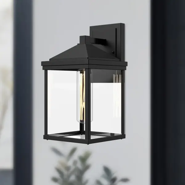 The Larchmont combines classic Spanish Colonial architecture with West Coast minimalism, creating a versatile outdoor fixture. Its textured black finish and clear glass shade deliver timeless appeal for modern homes. - alternate view