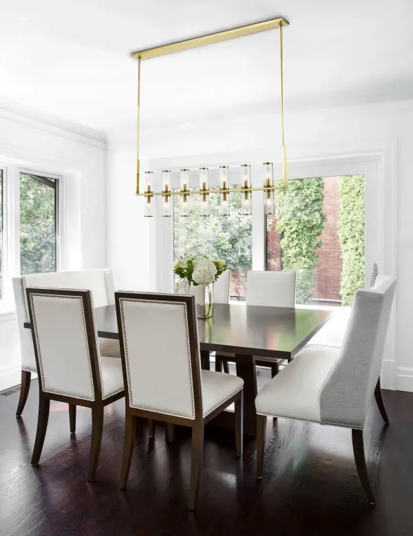 The Revolve Linear Pendant brings timeless elegance to dining and kitchen spaces with its antique candle-holder inspired design. Clear glass tubes accented with metal rings create a striking focal point that works beautifully in transitional interiors. - alternate view