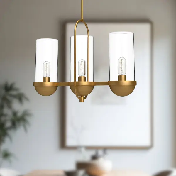 The Cyrus linear pendant blends 1920s public space aesthetics with modern farmhouse charm. Clear glass cylinders and decorative screws create authentic vintage character, while the aged gold finish adds warmth to any space. - alternate view