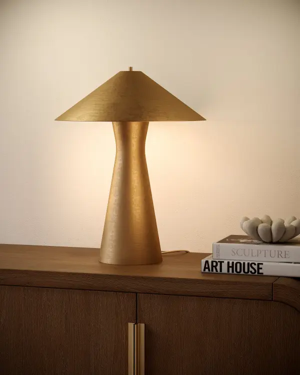 The Blair table lamp commands attention with its distinctive curved metal base and matching shade. This statuesque piece combines heavy-duty metal construction with contemporary design, making it a versatile statement piece. - alternate view