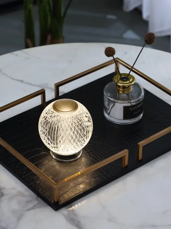 The Marni portable lamp combines sophisticated transitional styling with modern functionality. Featuring integrated LED lighting, rechargeable battery, and intuitive tap dimming, this compact lamp delivers warm ambient light wherever you need it. - alternate view