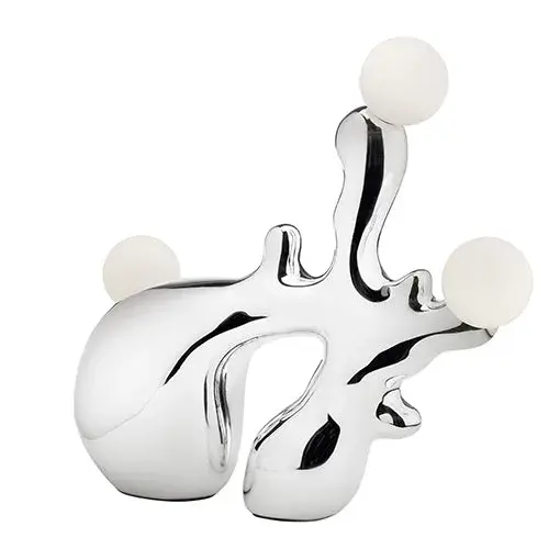 The Tearscape table lamp merges functional lighting with artistic sculpture through its fluid, jewelry-inspired design. Featuring three integrated LED lights with detachable diffusers and a decorative amorphous switch, this 14-inch lamp brings contemporary elegance to any space.