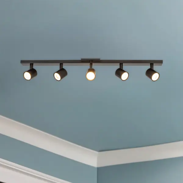 The Arnold 5-Head Track Light combines contemporary style with practical functionality. Featuring five adjustable cylinder heads on a sleek backplate, it offers customizable task lighting with integrated LED and selectable color temperatures. - alternate view