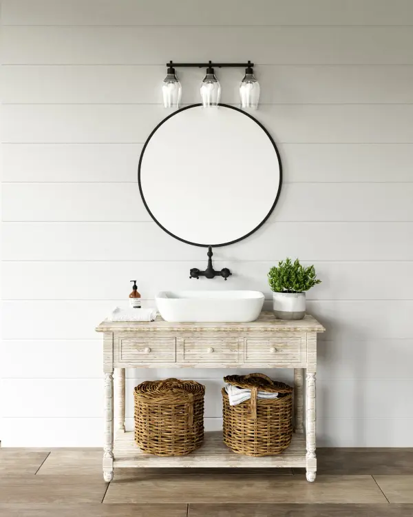 The Kingsley vanity light blends classic elegance with modern style through its strong metallic frame and three wine-glass shaped clear glass shades. Perfect for bathrooms and powder rooms seeking versatile design. - alternate view