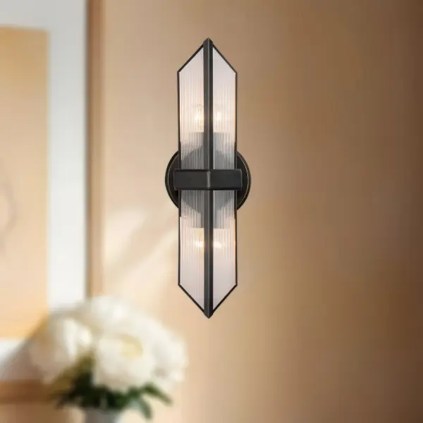 The Cairo vanity light brings museum-quality design to your bathroom with its Louvre pyramid-inspired geometry. Ribbed glass panels dance with vintage brass framing in this Elisa Carlucci design that elevates everyday spaces. - alternate view