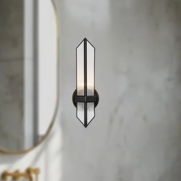The Cairo 4-Light Vanity Light brings architectural elegance to your bathroom with its pyramid-inspired design and ribbed glass shades. Designed by Elisa Carlucci, this transitional fixture combines strong metal frames with beautiful textured glass for a sophisticated, modern look. - alternate view