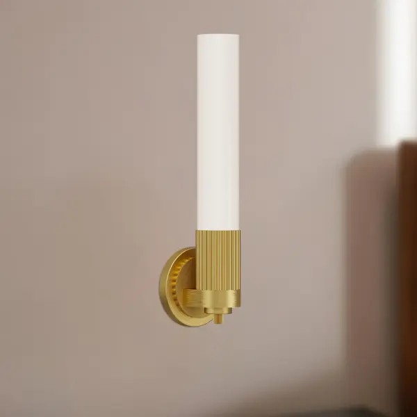 The Rue collection blends Parisian elegance with New York City sophistication through ribbed metal detailing and Glossy Opal glass. This 5-inch vanity light features skyscraper-inspired design elements in a stunning Brushed Gold finish, perfect for adding statement style to bathrooms and powder rooms. - alternate view