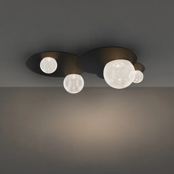 This oversized flush mount combines flat black ovals with cloudy opal glass spheres in a playful, otherworldly arrangement. Integrated LEDs provide warm 3000K illumination with excellent color rendering for a sophisticated ambient glow.