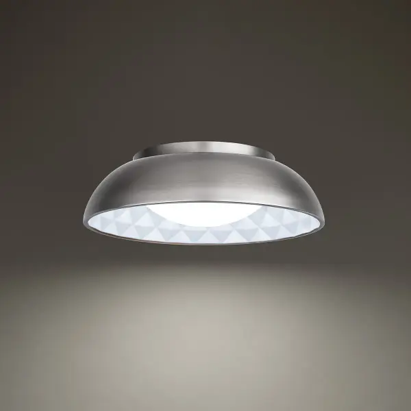 The Prisma flush mount combines mid-century modern aesthetics with contemporary LED technology. Its distinctive diamond-patterned detailing creates a prismatic effect through mouth-blown etched opal glass, delivering both style and high-performance illumination.