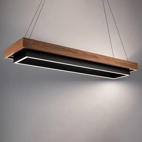 The Hustler Linear Pendant combines sleek black aluminum with warm dark walnut accents for a sophisticated billiard-inspired design. At 54 inches long, it delivers powerful 3304-lumen LED output perfect for dining tables and game rooms.