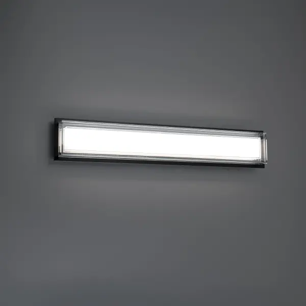 The Ice Bar vanity light combines contemporary design with practical functionality. Its substantial aged brass backplate and textured etched glass create soft, glowing illumination perfect for bathroom vanities. Adjustable LED color temperature ensures ideal lighting.