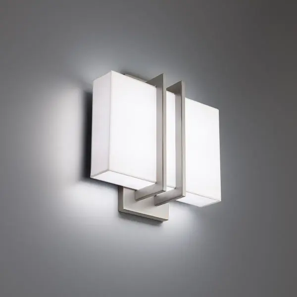 The Downton wall sconce combines clean architectural lines with luxe fabric shading. Features switchable color temperatures (2700K-3500K) and ADA compliance, making it ideal for hospitality and residential applications alike.