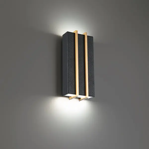 The Poet Wall Sconce combines handsome black pebbled leather with aged brass accents for a refined, luxurious aesthetic. Dual LED modules provide both upward and downward illumination at 3000K, creating warm ambient light with excellent color rendering (CRI 90). Perfect for adding sophisticated style to intimate spaces.