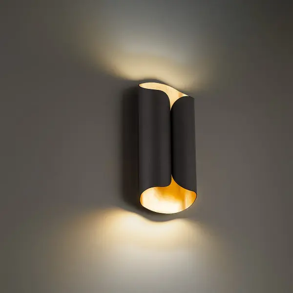 The Opus wall sconce combines abstract expressionist design with practical LED efficiency. Its bronze and gold leaf finish creates visual drama while the silk screen glass diffuser provides warm, ambient illumination perfect for modern interiors.