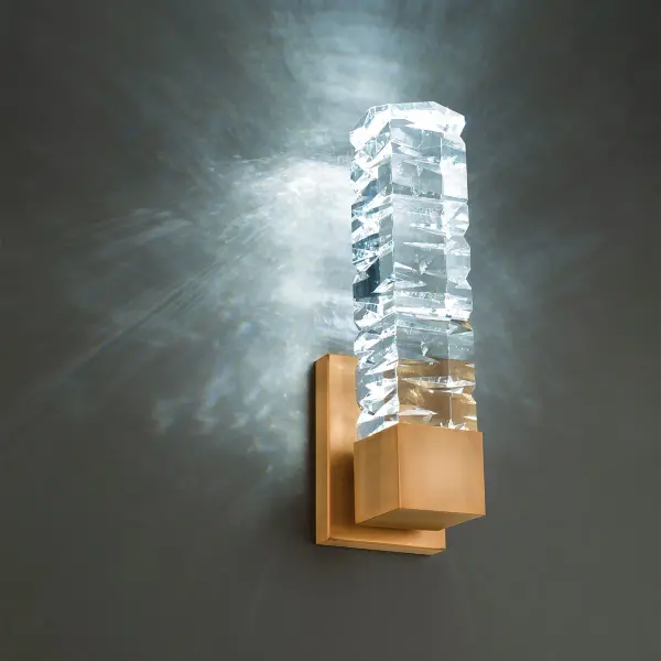 The Juliet wall light combines dramatic faceted crystal spears with warm aged brass for a luxurious, sculptural statement. Its prismatic texture creates captivating light play while the energy-efficient LED delivers excellent color rendering.
