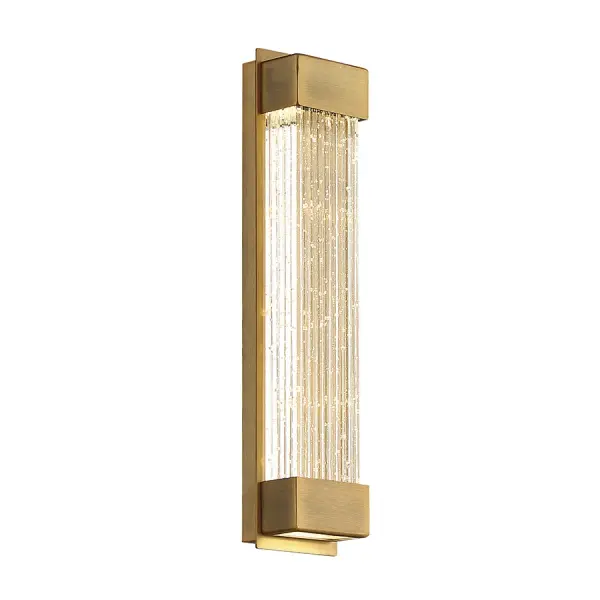 The Tower sconce combines trending aged brass with V-cut seeded crystal for understated luxury. Dual LED modules illuminate the crystal while providing hidden up/downlight for layered ambience and functional illumination.