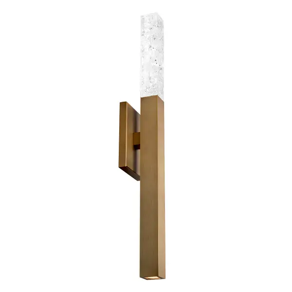 The Minx Wall & Bath Light combines reclaimed crystal fragments with modern LED technology for a stunning vertical accent. Its 26-inch height and dual-direction lighting create dramatic ambiance while the aged brass finish adds warmth.