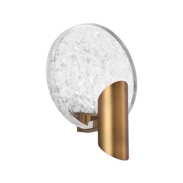 The Oracle Wall Sconce combines handmade reclaimed optical crystal with indirect LED illumination for a dramatic, crackling effect. Perfect for luxury interiors seeking sophisticated ambient lighting with artisanal character.