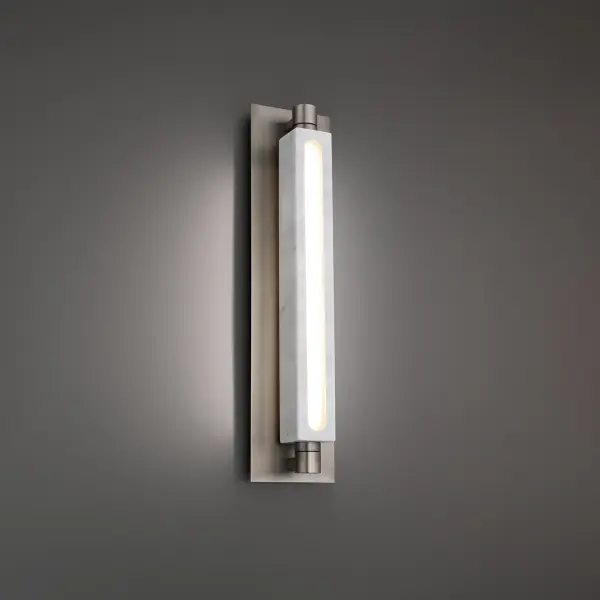 The Stanchion combines polished white marble with brushed nickel and opal glass for a sophisticated look. Its 360-degree rotating centerpiece allows precise light direction, while dual-sided LED illumination creates ambient warmth.