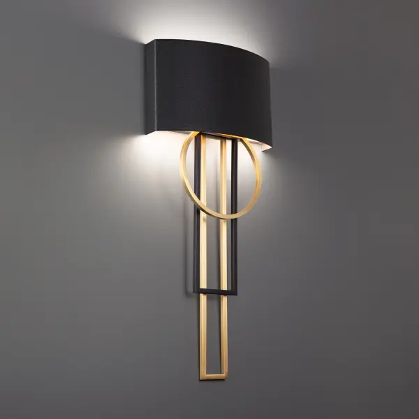 The Sartre wall sconce combines architectural geometry with rich leather craftsmanship. Its 32-inch vertical profile creates dramatic impact while the mixed metal finish and topstitched leather shade add warmth and texture to modern interiors.
