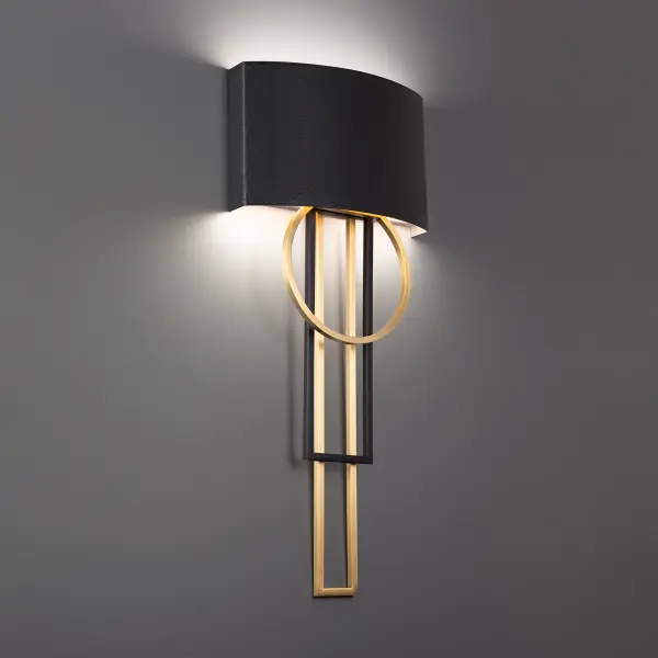 The Sartre wall sconce combines architectural geometry with rich leather craftsmanship. Its 32-inch vertical profile creates dramatic impact while the mixed metal finish and topstitched leather shade add warmth and texture to modern interiors.