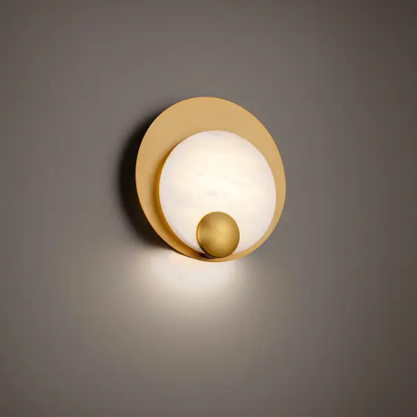 The Rowlings wall sconce combines natural alabaster stone with aged brass circular plates for an artful, sophisticated look. High-output LED technology delivers warm 3000K illumination while highlighting the stone's natural variations.