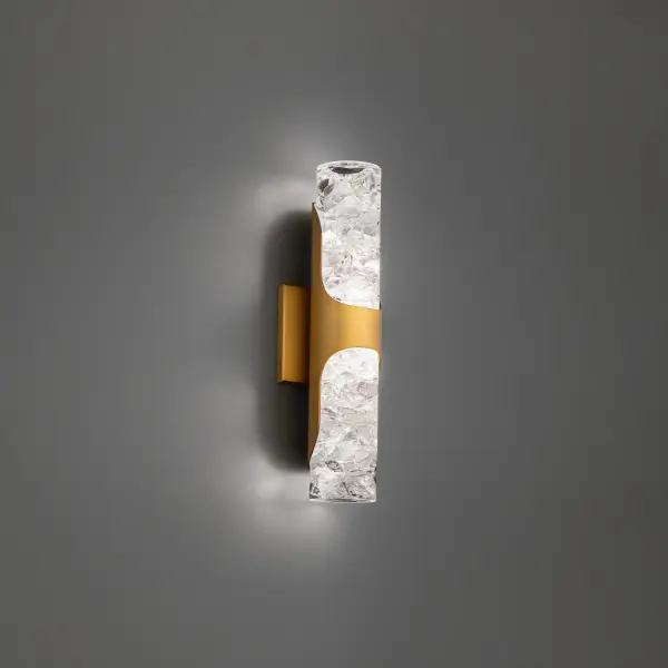The Royce wall sconce transforms reclaimed K5 crystal shards into dazzling illumination, encased in a sleek curved metal frame. Its 16-inch profile delivers both ambient and decorative lighting with exceptional energy efficiency.