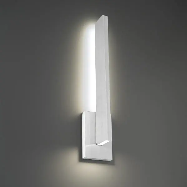The Mako delivers striking modern aesthetics with dual blade lighting—one highlighting its angular silhouette, another illuminating pathways below. ADA compliant and wet-rated for versatile indoor/outdoor use with energy-efficient LED technology.