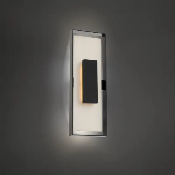 The Boxie outdoor wall sconce combines bold three-dimensional geometric forms with efficient LED technology. Its strategic play of light and shadow creates dramatic visual interest while delivering 720 lumens of warm 3000K light.