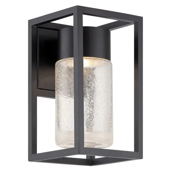The Structure wall sconce combines modern architectural design with eco-conscious dark sky lighting. Its raindrop glass cylinder suspended in a sleek frame creates a magical crystallized effect while preserving night sky visibility.