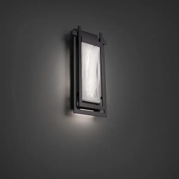 The Haze outdoor wall sconce delivers striking illumination through hand-crafted pressed glass with an etched back surface. At 22" tall, it creates dramatic light patterns perfect for modern and transitional exteriors.