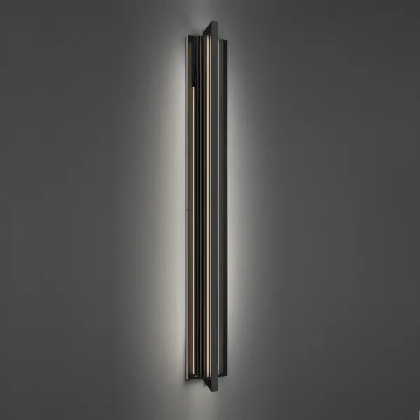 The Krimp outdoor wall sconce makes a bold architectural statement with its 60-inch extruded aluminum frame featuring a distinctive ribbed front surface. Integrated 3000K LEDs illuminate from behind, creating dramatic up and down wall washing effects while highlighting the textured grooves. ETL-rated for outdoor use with exceptional 50,000-hour LED lifespan.