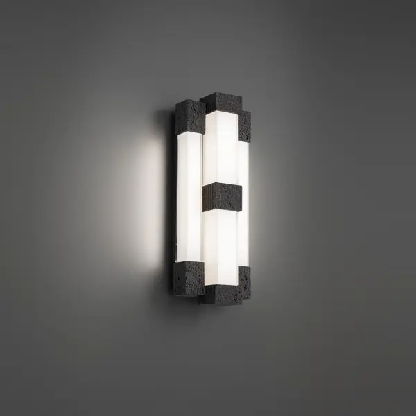 The Conan Wall Sconce merges raw natural basalt stone with precision-cut glass and modern aluminum craftsmanship. At 28" tall, it creates dramatic vertical presence with soft ambient lighting, perfect for contemporary spaces.