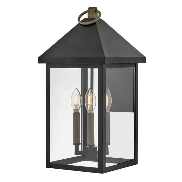 The Rhett wall lantern combines classic lantern styling with modern transitional appeal. Tall glass panes under an oversized pyramid roof create architectural interest, while the Black and Burnished Bronze finish adds sophisticated contrast.
