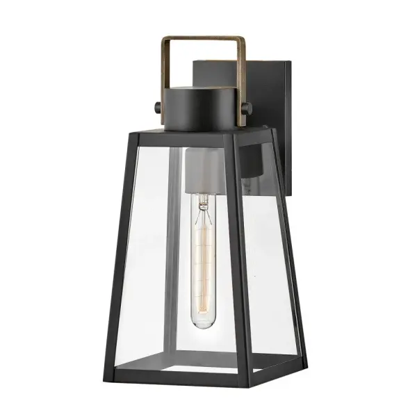 The Hugh outdoor wall lantern delivers sophisticated transitional design with its trapezoidal silhouette and oversized clear glass panes. The two-tone Black and Burnished Bronze finish adds warmth and modern appeal to porches, patios, and entryways.