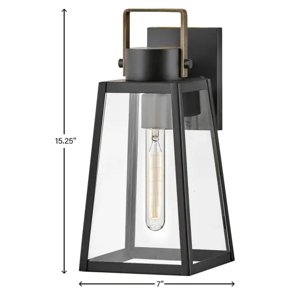 The Hugh outdoor wall lantern delivers sophisticated transitional design with its trapezoidal silhouette and oversized clear glass panes. The two-tone Black and Burnished Bronze finish adds warmth and modern appeal to porches, patios, and entryways. - alternate view