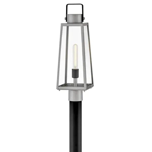 The Hugh post mount lantern delivers sleek transitional design with oversized clear glass panes and sophisticated two-tone metal finishes. Its trapezoidal silhouette adds architectural interest to porches, patios, and entryways.