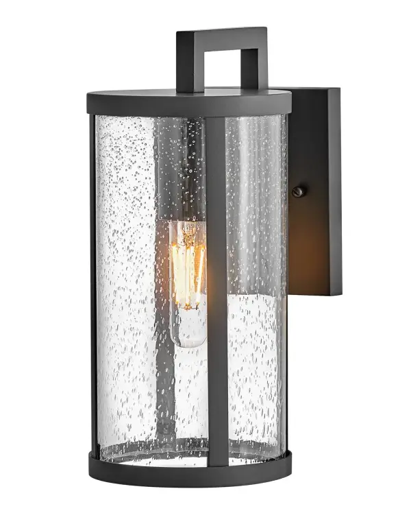 The Alfie Small Wall Lantern combines timeless cylindrical styling with clear seedy glass for a versatile outdoor lighting solution. Its compact 6-inch width makes it ideal for smaller exterior spaces while delivering impactful illumination.